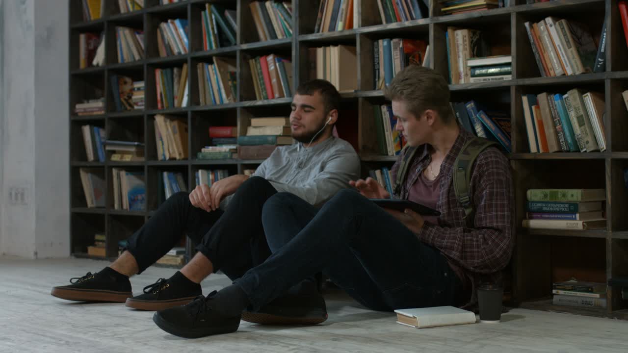 Hipster students studying in library at university
