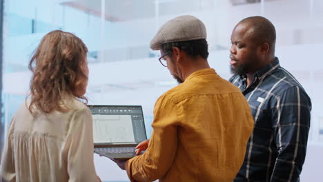 business team evaluating architectural blueprints layout for high class office