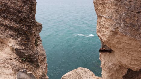 black sea coast waves between vertical cliffs at cape kaliakra in bulgaria