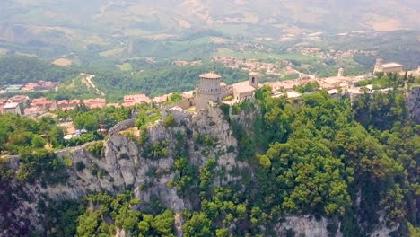 aerial view of guaita tower on mount titano overlooking the city in san marino bordered by italy