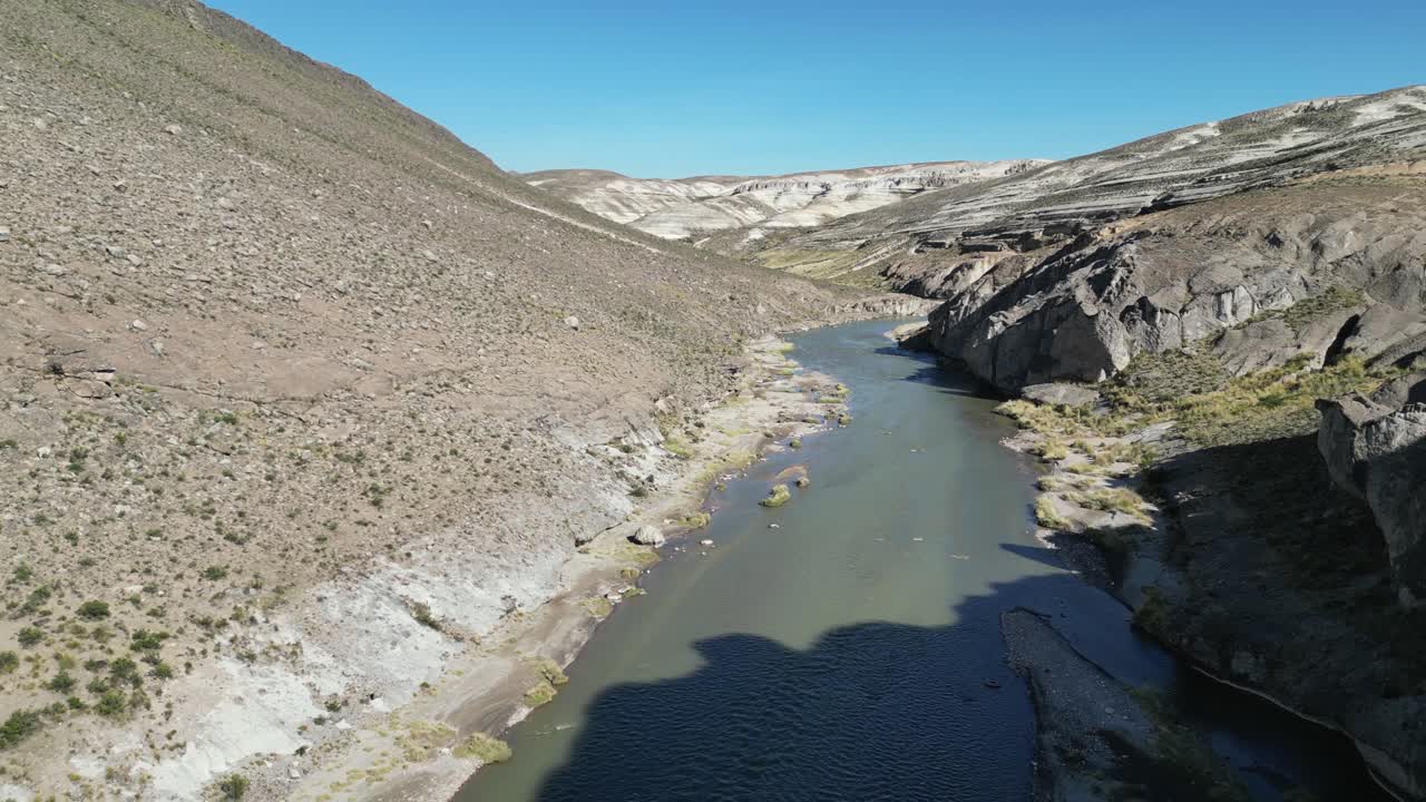 Aerial flight down Sumbay River past barren rock cliffs, Peru nature