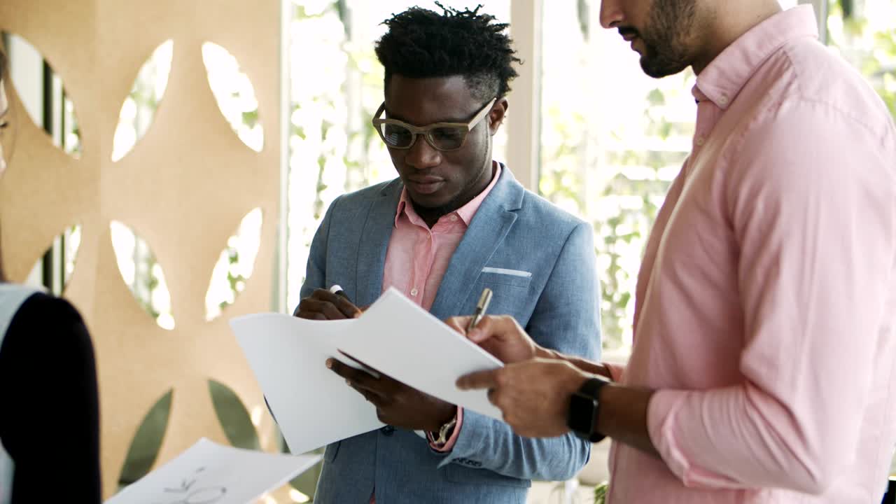 Focused African American employee writing with marker