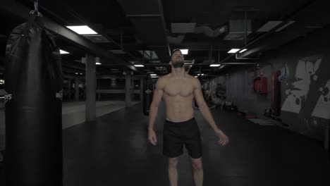 Young-athletic-man-doing-pull-ups-at-the-gym