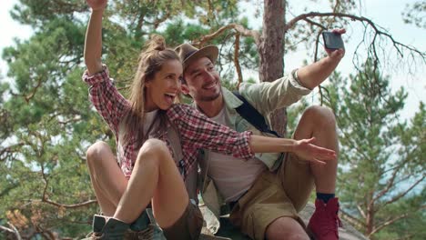 playful backpackers making a selfie