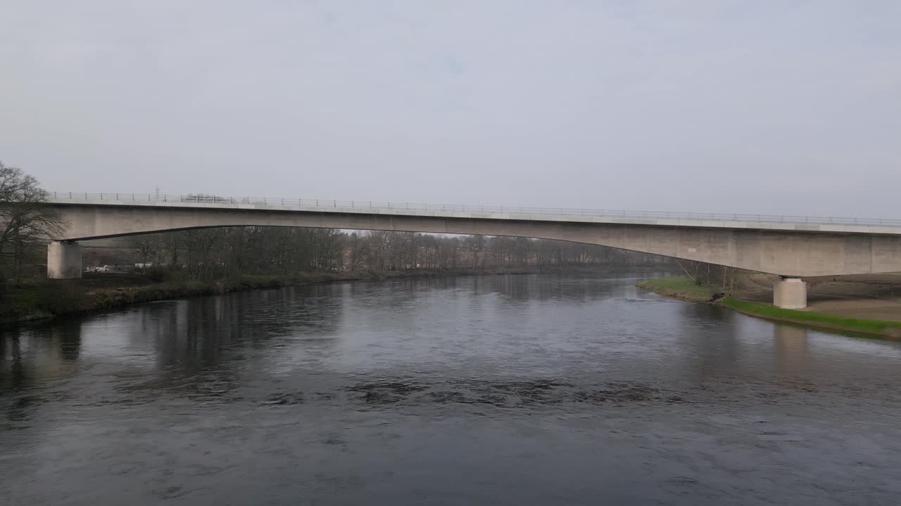 Destiny Bridge above River Tay before the official opening. Drone flying under the bridge close to the water.