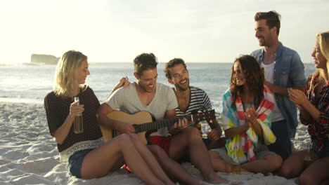 friends sitting and playing guitar