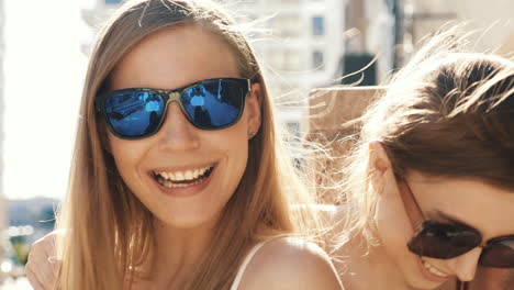 two women laughing outdoors