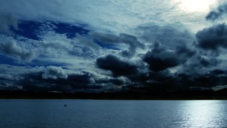 time lapse of a dramatic sky at dusk, with normal speed for the lake