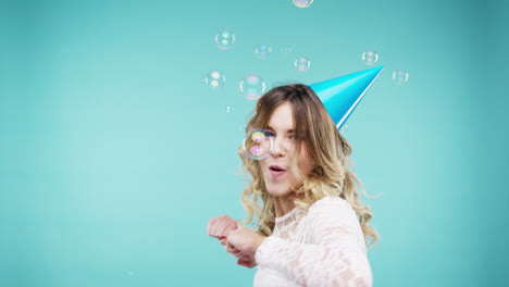 Crazy-face-woman-dancing-in-bubble-shower-slow-motion-photo-booth-blue-background