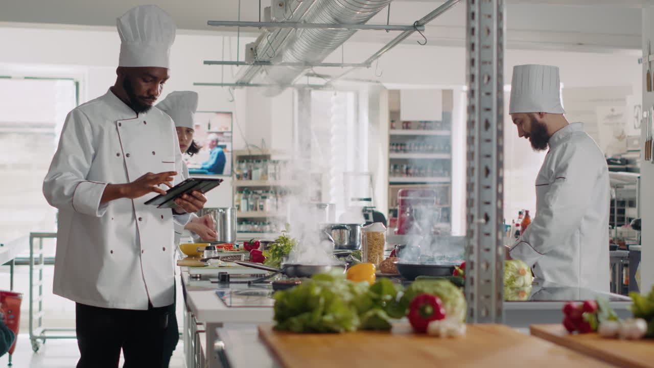 African american cook looking at online recipe on digital tablet