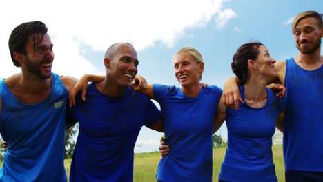 Group-of-people-standing-standing-together-with-arms-around-4k