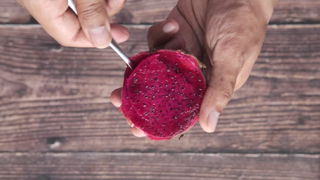 persona comiendo una fruta de dragón