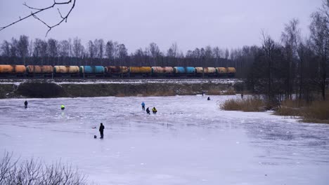 along the lake where a train passes by ice fishing