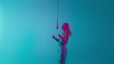 woman singing in a neon studio