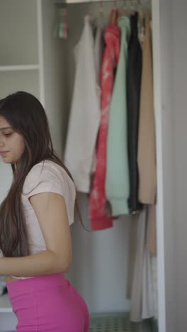 woman choosing clothes from a closet