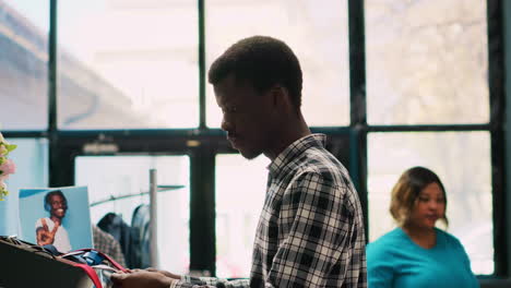 Stylish man analyzing tie fabric