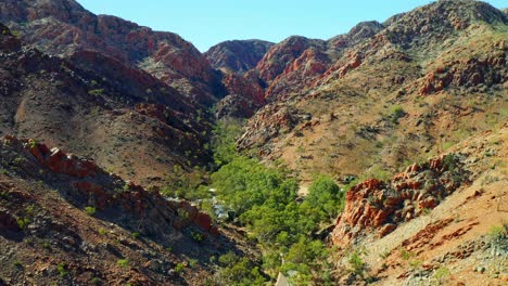 asphalt road at the valley of mountain range in west macdonnell national park in northern territory, australia