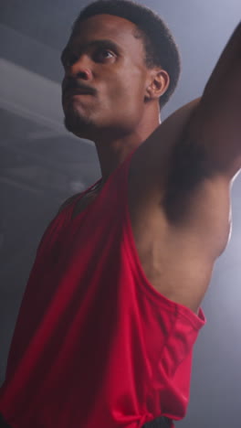 Vertical-Video-Of-Male-Boxer-Entering-Ring-Before-Start-Of-Boxing-Match-Waving-Gloves-And-Greeting-Fans