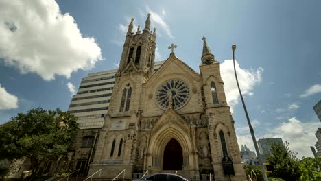 time lapse of clouds over the austin cathedral with traffic