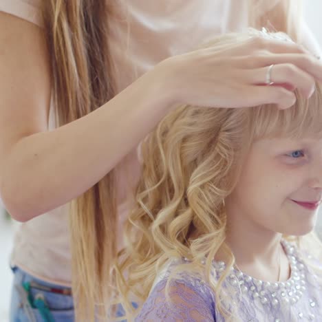 a young lady is doing an elegant hairstyle 1