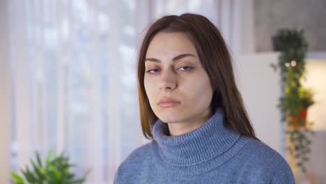 Portrait-of-a-young-woman-looking-dull-at-the-camera.