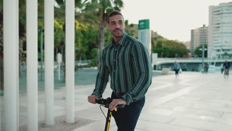 young man riding a scooter outdoors.