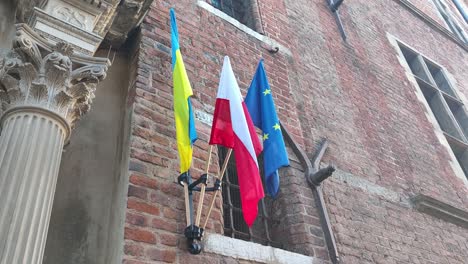 flags of ukraine, poland and the european union. symbol of solidarity with ukraine after russian invasion.