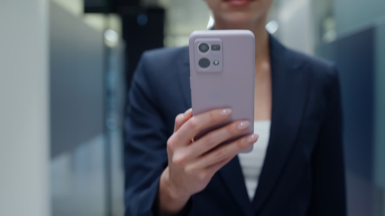 Lady hands using smartphone strolling hall closeup. Woman watching schedule
