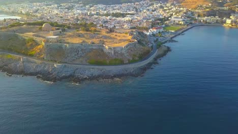 flying a drone away from fortezza rethymno over the mediterranean sea in crete greece