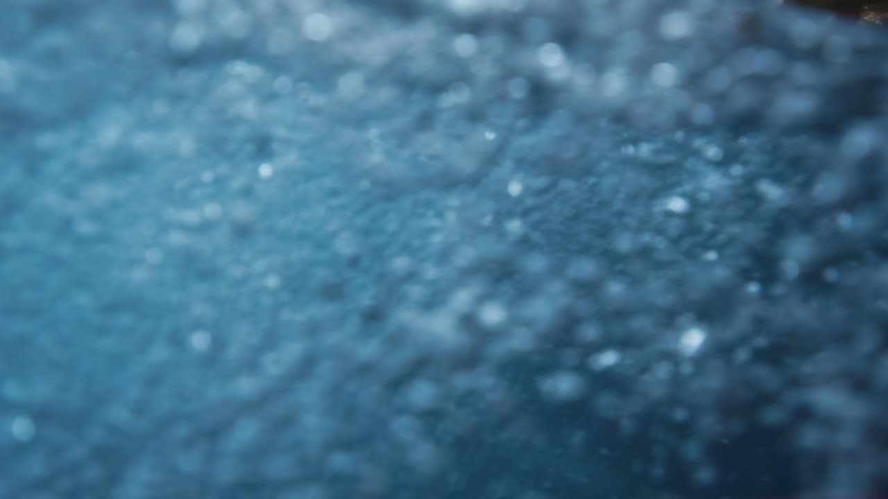 Clear stream running through stone boulders