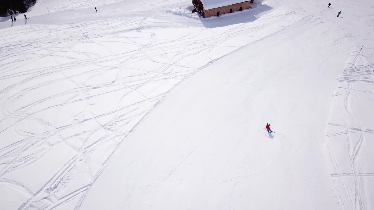 4k aerial footage, drone following skiers on ski slope in skiing region