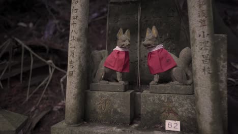 zoom out shot of holy japanese fox statue in fushimi inari shrine,japan