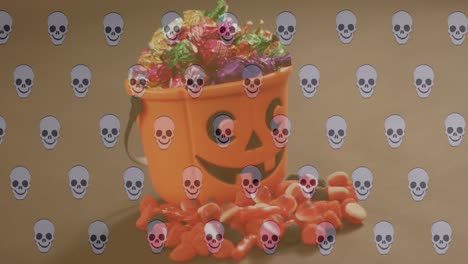 Animation-of-skull-icons-over-halloween-box-of-candy