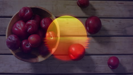 bowl of red apples on wooden table with sunset animation overlay