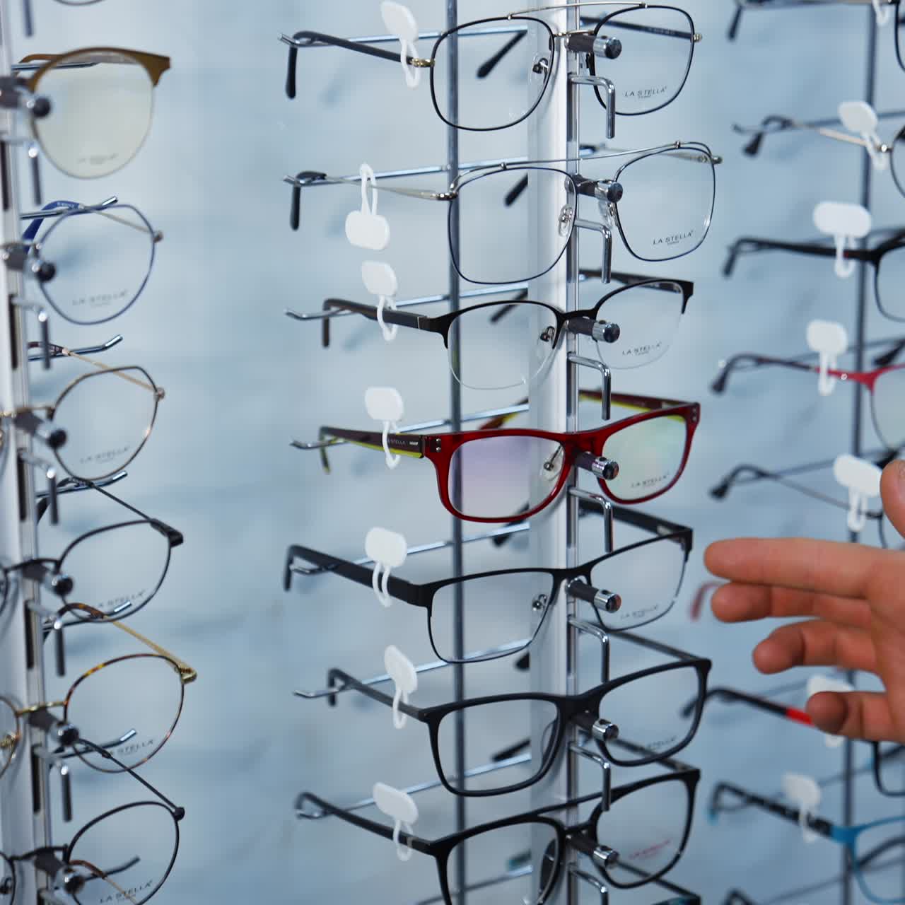 Uomo che sceglie occhiali in un negozio di ottica