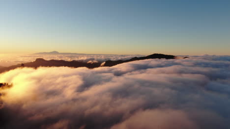 sunset above the clouds: aerial view of majestic mountains