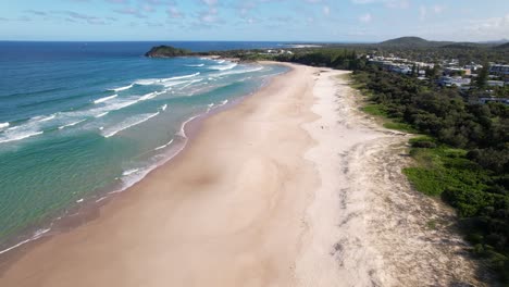 view from above of coastal paradise cabarita beach with norries headland in distance. new south wales, australia. aerial pullback shot