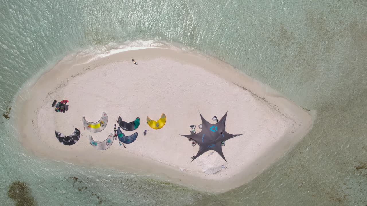 Numerous kites stationary on sand