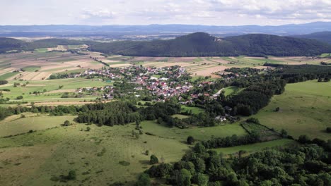 small-rural-town-during-a-sunny-day-seen-from-above,-zoom-in-reveal