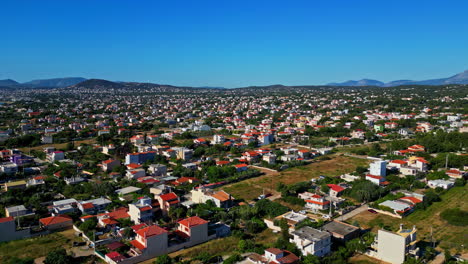 Aerial-View-Over-Neighborhood-In-Suburban-Area-Surrounded-With-Mountains-And-Ocean---Drone-Shot