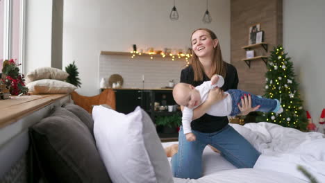 mother and baby on bed