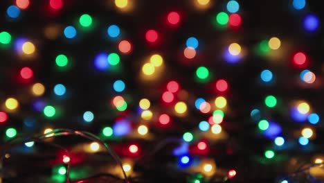 beautifully lit multicolored christmas lights on a black background, copy space.