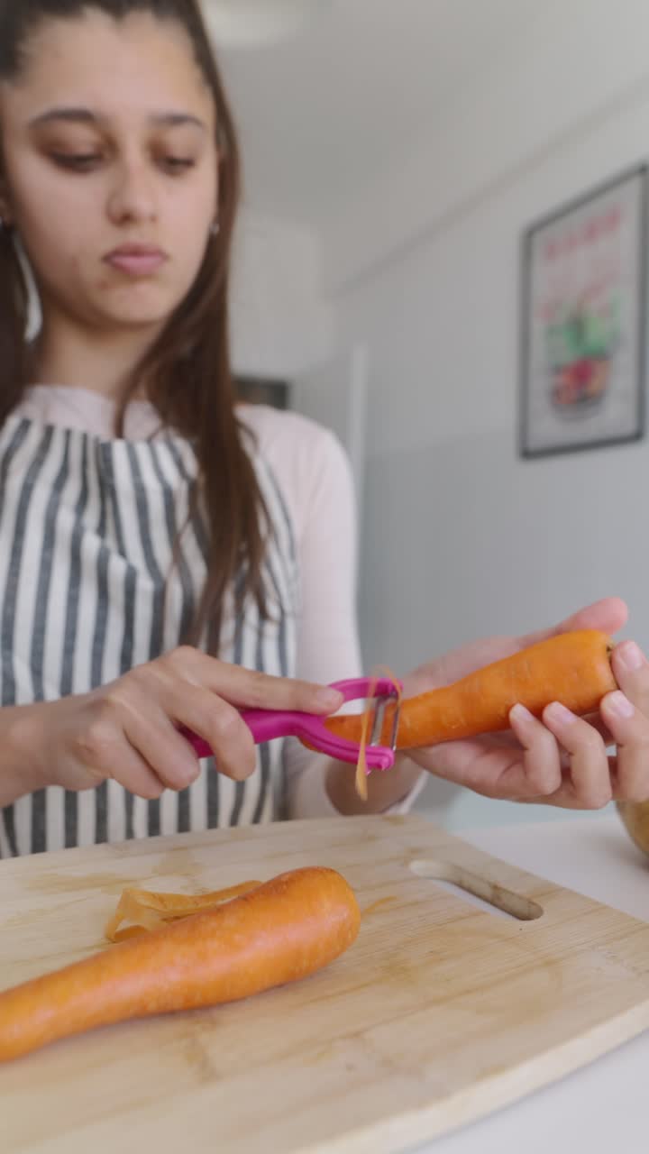 Teenage girl peeling carrots