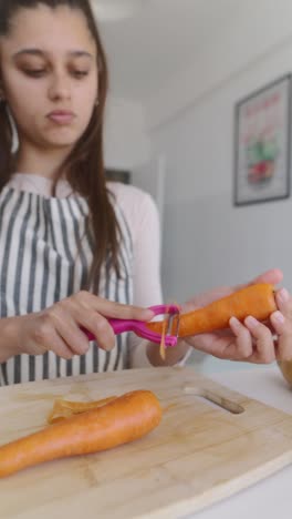 teenage girl peeling carrots