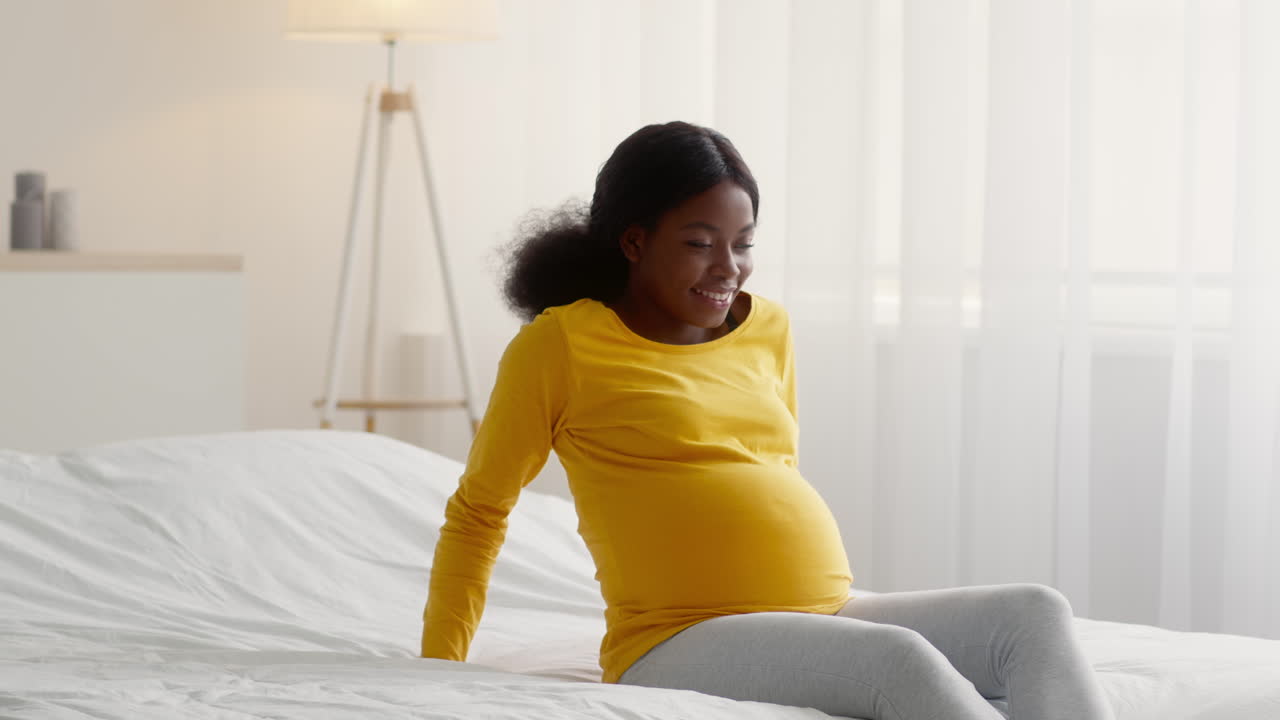 Pregnant Woman Relaxing on Bed