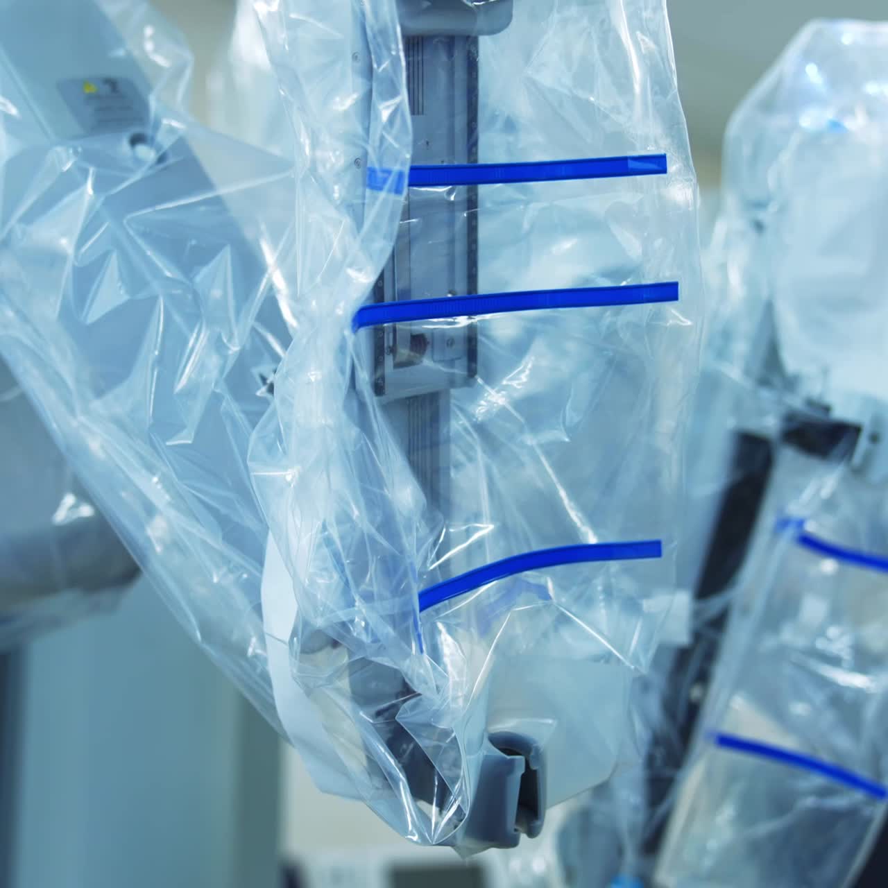 Da Vinci robotic equipment in modern hospital surgery room. Robotic arms covered with plastic and disconnected devices. Close up