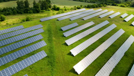 ecology solar power station panels in green field, renewable energy, aerial