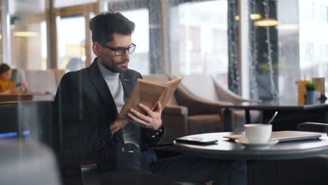 man reading in a cafe