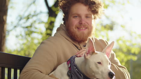 portrait of happy man with dog in park