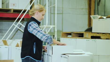 a woman with a tablet holds inventory in a warehouse